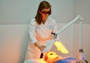 woman performing corrective light therapy